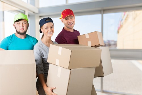 Movers navigating a building move in Soho with furniture