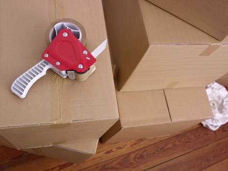Removal workers loading boxes and furniture from a central London property